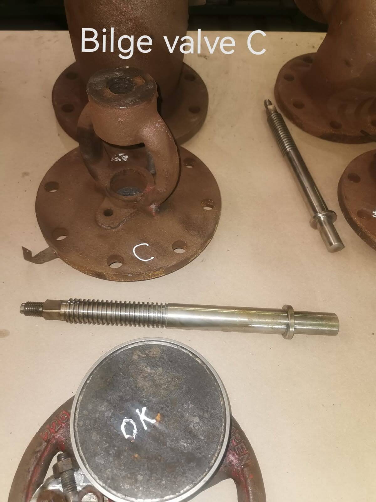 Dismantled marine bilge valve with body, spindle and internal components identified